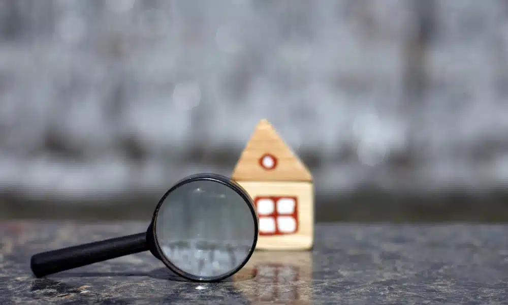 a magnifying glass looking at a small toy house