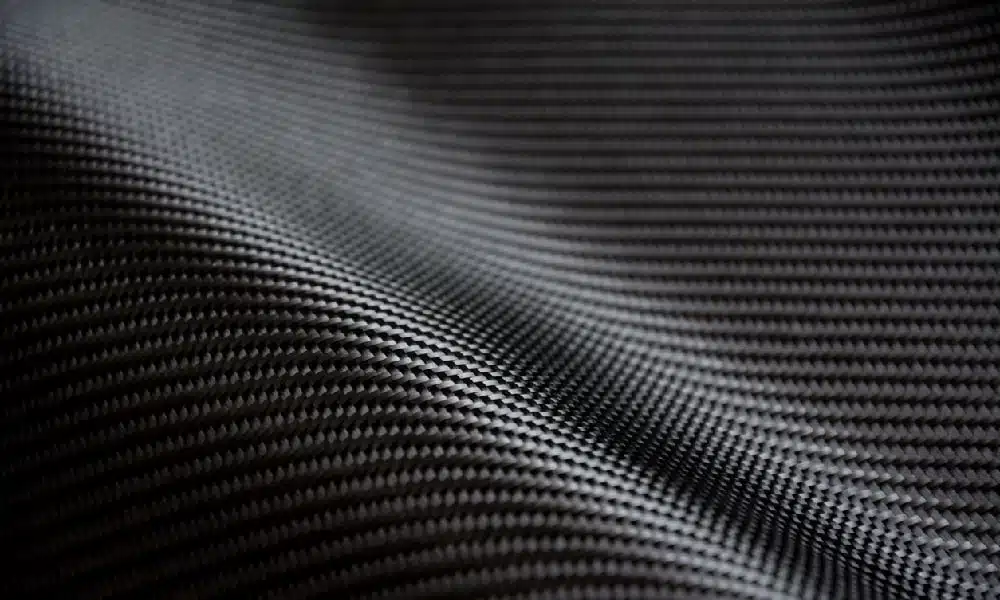 An extreme closeup shows dark gray carbon fiber composite, which could be used in carbon fiber foundation repair.
