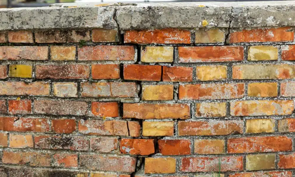 a cracked brick wall that needs mortar repair