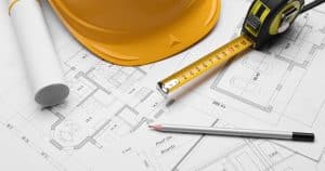 a blueprint of a kitchen with construction tools representing the process of a safe and successful kitchen remodel