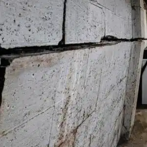 A bowing wall with visible crack, indicating wall bowing as the cause of gap between floor and wall in Reston, VA