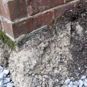 Erosion of soil near the foundation, showing soil movements as a primary cause of gap between floor and wall in Berkeley, WV