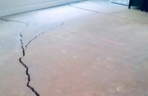 A visible cracks in the concrete slab foundation, indicating a clear sign of gap between floor and wall in Charles Town, WV