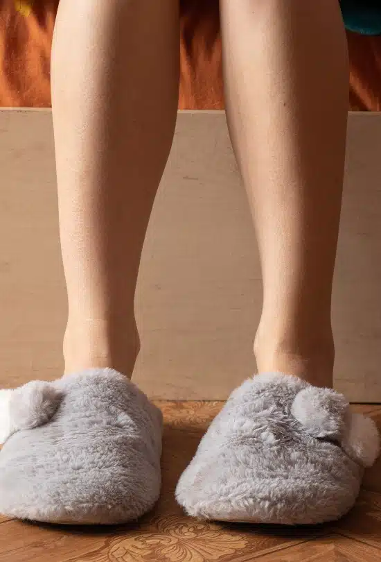 A girl wearing indoor slippers to prevent the cold floor, a sign that needs solution to reduce cold floor in Northern Virginia.