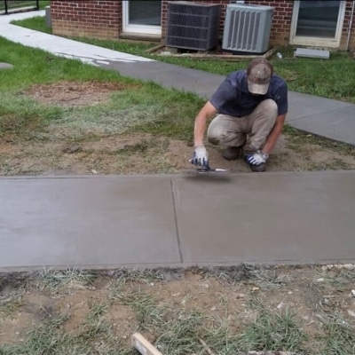 A man doing concrete resurfacing in White Post, VA, an effective solution for addressing chipping concrete.