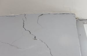 An image displaying multiple cracks in concrete walls, serving as a clear sign of damage drywall cracks in Charles Town, WV