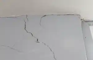 An image displaying multiple cracks in concrete walls, serving as a clear sign of damage drywall cracks in Charles Town, WV