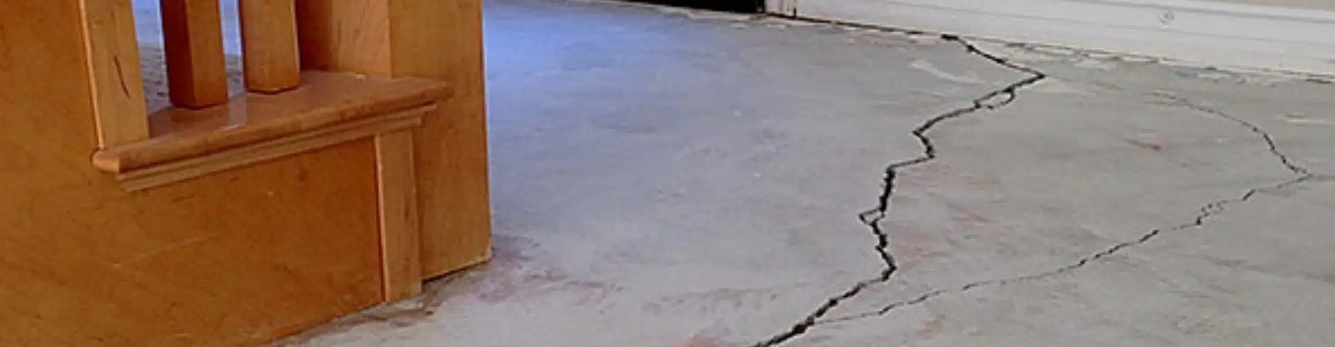 Multiple cracks in basement floor in White Post, VA, a clear sign of foundation problems.