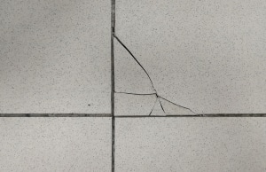 Cracks in floor tiles, one of the signs of uneven floors in Southbridge, VA.