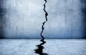 An image showing deep cracks in walls or floors as visible indicators of a damp basement in Clear Brook, VA
