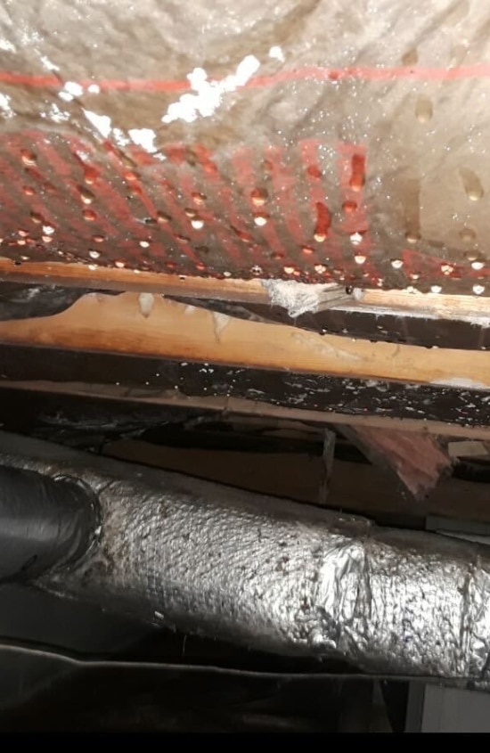 A crawl space ceiling with condensation forming, a sign that needs crawl space condensation solutions in Northern Virginia.