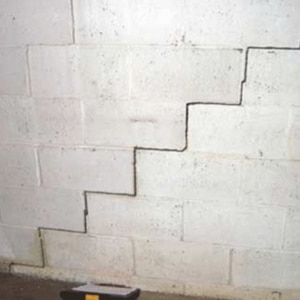 An image of a foundation with visible crack, highlighting foundation cracks as a cause of a damp basement in Berkeley, WV