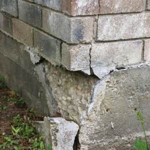 A collapsed, large section of foundation edge, showing foundation cracks as the cause of unlevel floors in Harpers Ferry, WV.