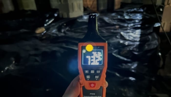 A hygrometer showing high humidity levels in crawl space in Northern Virginia, a symptom of underlying crawl space problems.