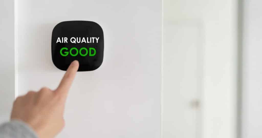 A hand pointing to good air quality button, denoting that home dehumidifier is an indoor air quality solution in Harpers Ferry, WV.