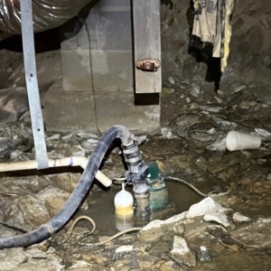A dirty and damp crawl space with water accumulation due to plumbing leaks that can cause mold in crawl space in Winchester, VA.