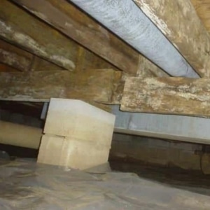 Damaged crawl space floor joist, showing poor structural design as the cause of sagging floors in Reston, VA.