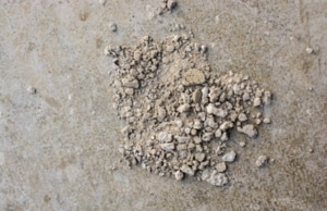 Small pieces or chips of concrete scattered on the ground, a sign of chipping concrete surface in Gainesville, VA