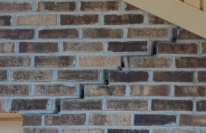 A stair-step cracks in the foundation brick wall, a sign of foundation cracks in Linden, VA