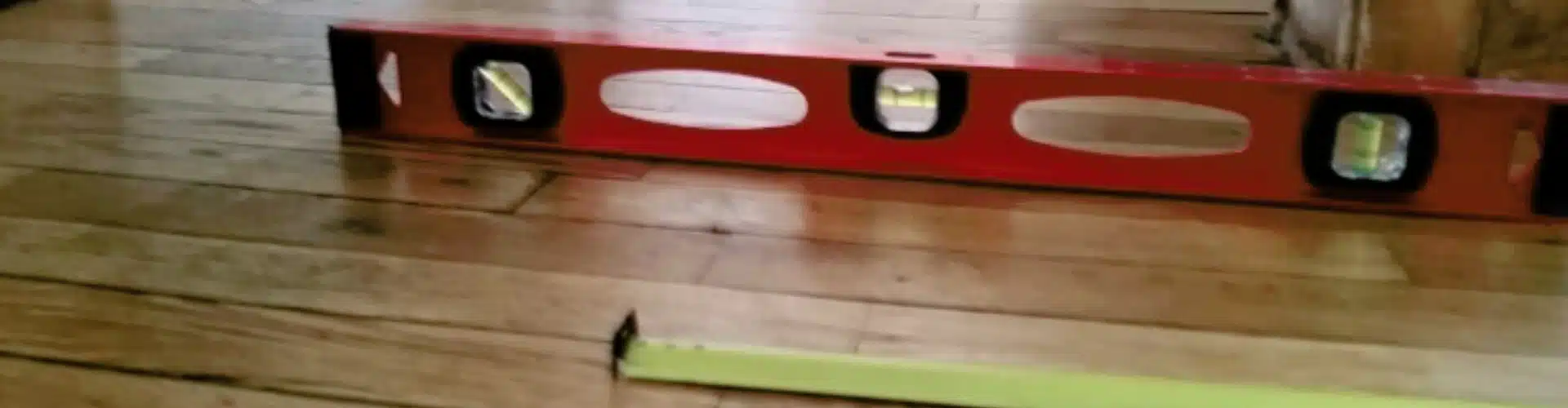 A measuring tool placed on the floor, showing uneven floor in Stephens City, VA, as a common sign of a foundation problem.