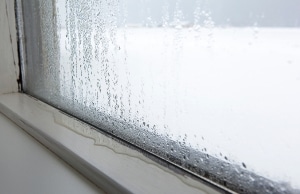 A closed window with water seeping in, showing unregulated humidity as a sign of sticking doors and windows in Stephens City, VA