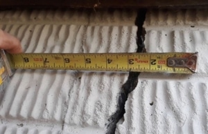 An image of a deep vertical crack, a clear sign of structural stress and cracks in concrete walls in Martinsburg, WV