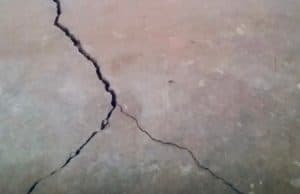 Visible multiple cracks on the floor, indicating signs of cracks in the basement floor in Clear Brook, VA
