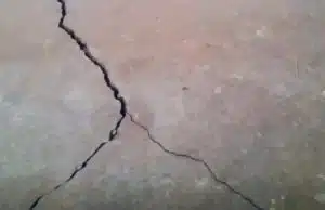 Visible multiple cracks on the floor, indicating signs of cracks in the basement floor in Clear Brook, VA
