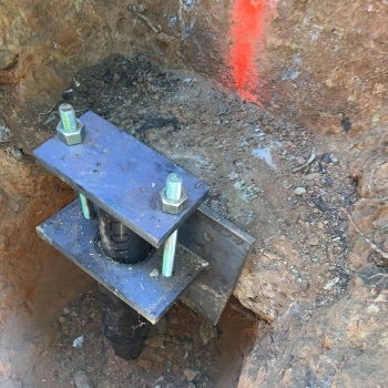 A hydraulic hydraulic lift cylinders lifting the foundation for push piers installation in Flint Hill, VA.