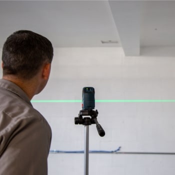 A man assessing the foundation wall with problems that need push piers installation in Clear Brook, VA.