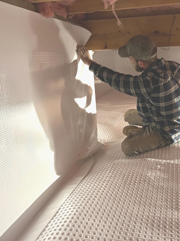 LUX team installing vapor barrier as part of effective crawl space encapsulation in Warrenton, VA