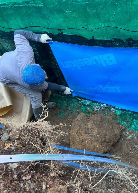 Image of LUX team installing exterior basement waterproofing in Front Royal, VA, for comprehensive moisture protection.