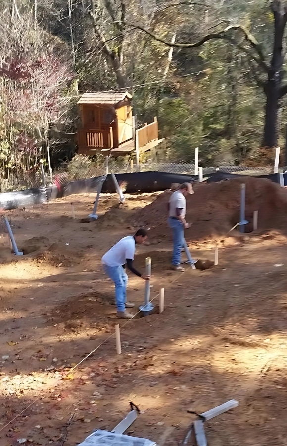 Image of LUX team performing helical piers installation in Berkeley, WV, for structural reinforcement.