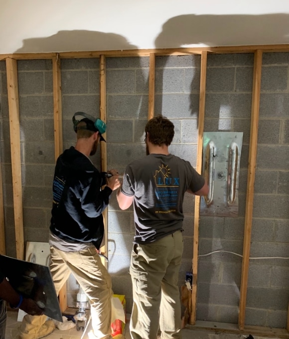 LUX team performing Wall Anchors installation in Fairfax, VA, to anchor and stabilize foundation walls in stable soil.