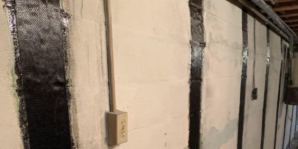 Carbon fiber straps installed on basement walls for carbon fiber foundation repair for structural integrity and stability.