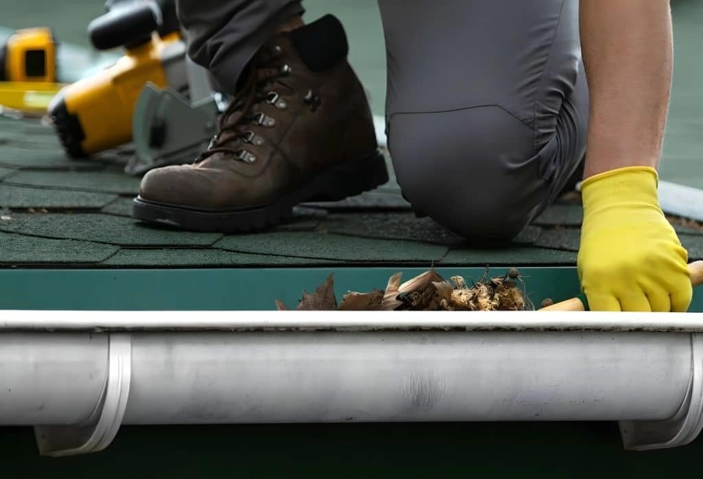 A clogged downspout, posing a risk of basement water damage in Brambleton VA.