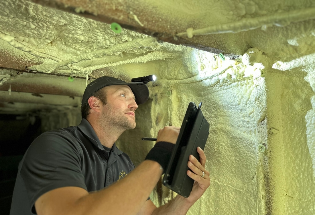 A qualified inspector examines a home’s foundation for interior cracks during a foundation inspection.