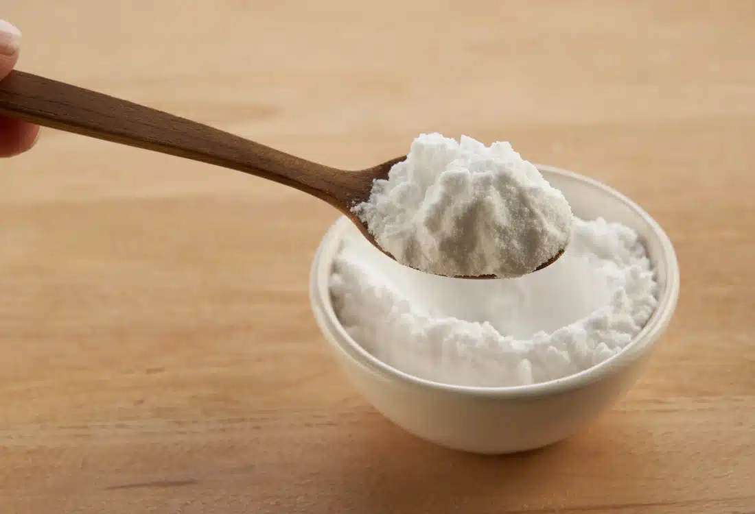 Bowls filled with baking soda, activated charcoal, and coffee grounds placed on a basement floor to absorb odors.