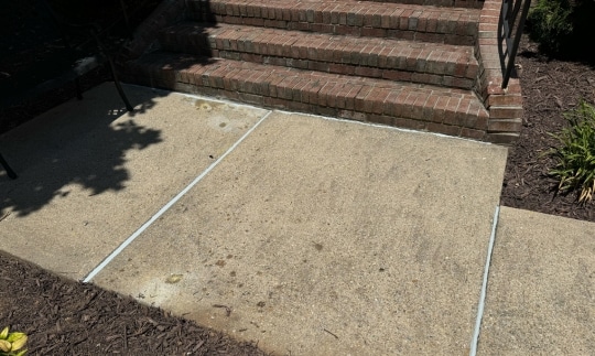 An image of finished uneven sidewalk concrete repair through polyurethane foam lifting, ensuring safety.