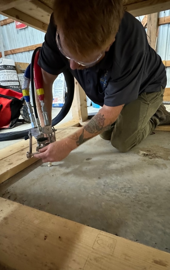 A LUX contractor lifting a sunken concrete garage floor, restoring its levelness and preventing further damage.