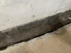 Trenching and concrete removal during a basement waterproofing project in Berryville, VA.