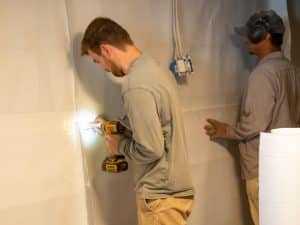 A vapor barrier installed on foundation walls during basement waterproofing in Front Royal, VA.