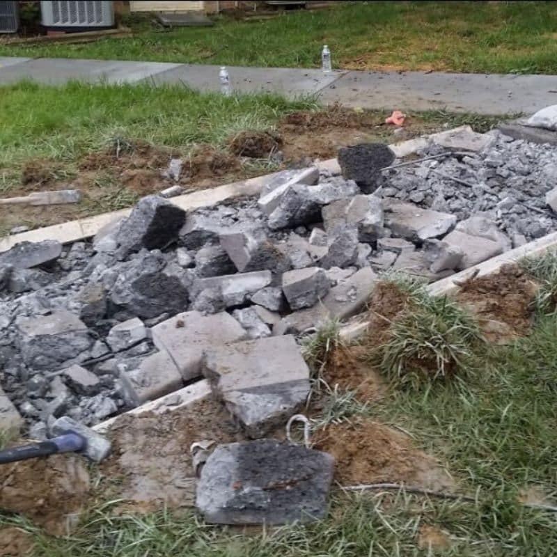 LUX team finishing the concrete sidewalk to replace a severely damaged and uneven sidewalk in Martinsburg, WV.