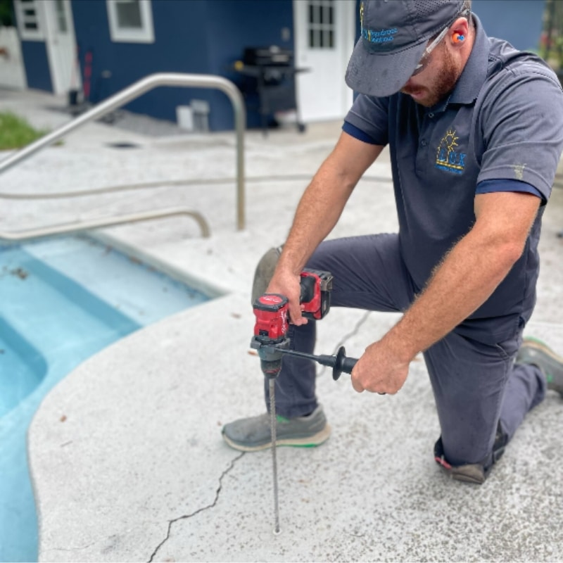 LUX team injects polyurethane foam beneath a sunken pool deck in Winchester, VA, lifting it as part of crack repair.