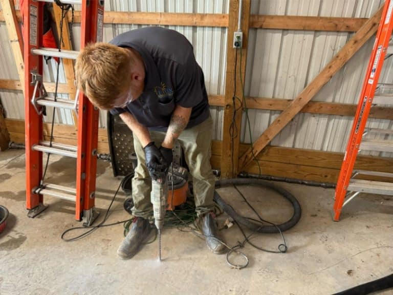 LUX team drilling holes in concrete slab for polyurethane foam injection as part of concrete lifting repair in Clear Brook, VA.