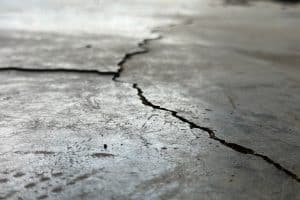 Cracks running through a concrete garage floor, a potential structural issues and sign of cracked garage floor in Alexandria, VA.