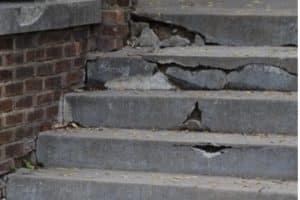Cracks in porch surface and where it meets the house, indicating sign of a sunken porch in Harpers Ferry, WV.