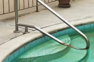 Gaps forming between the pool deck and the pool edge, a sign of sunken pool deck in Charles Town, WV, need concrete repair.