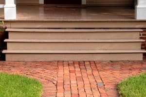 Visible gaps between wooden porch and stair steps, a sign of a sunken porch in Reston, VA, that requires concrete repair.