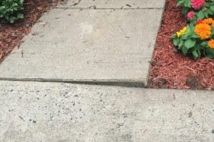 Lifted and sinking concrete sections showing instability and signs of uneven sidewalks in Gainesville, VA.